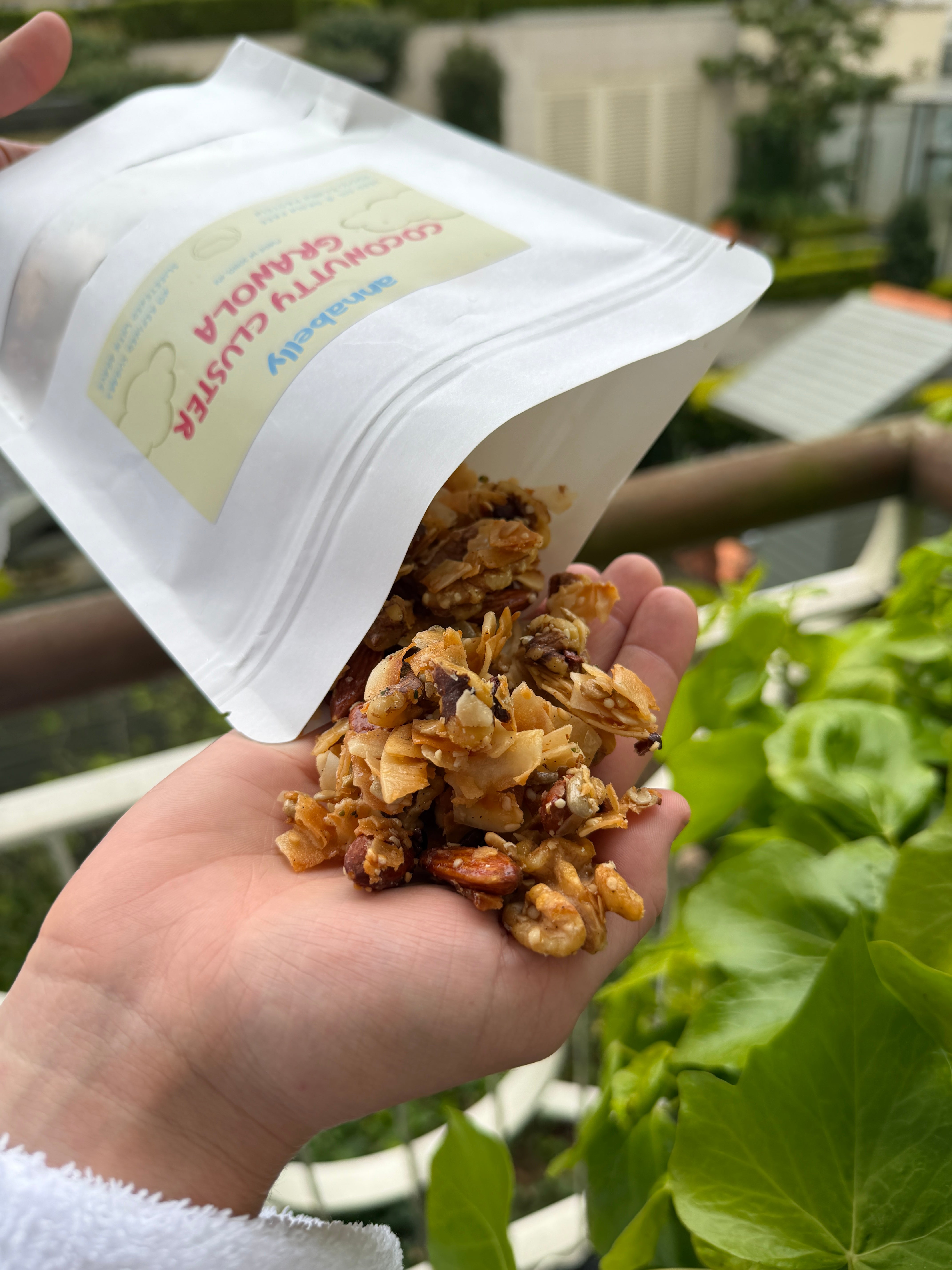 Annabelly's Coconutty Clusters granola in hand